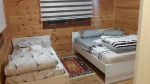 a room with two beds and a futon at AYDER ŞAFAK Apart in Ayder Yaylasi