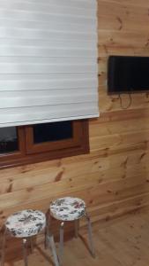 a room with two stools and a window with blinds at AYDER ŞAFAK Apart in Ayder Yaylasi