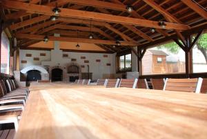 a large wooden table in a large room with chairs at Ubytovanie Tri ruže in Krásnohorské Podhradie