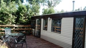 a patio with a table and chairs on a deck at Domek MatDar in Mikołajki