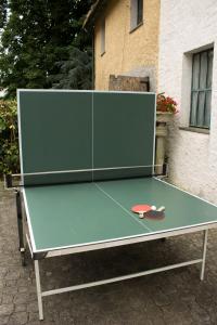 a ping pong table in front of a building at Margherita Guest House in Coreglia Ligure