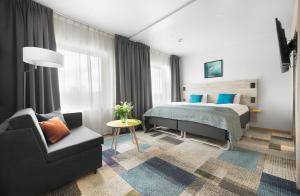 Postel nebo postele na pokoji v ubytování ArenaHotellet i Uppsala
