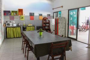 a dining room with a black table and chairs at Hostel de los Colores in Piriápolis