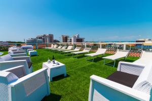 a row of chairs and tables on a roof at Hotel Romantik & Depandance in Lignano Sabbiadoro