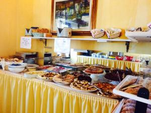 a buffet line with many different types of food at Santa Maria Resort in Orosei