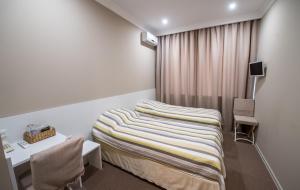 Postel nebo postele na pokoji v ubytování light hotel & hub