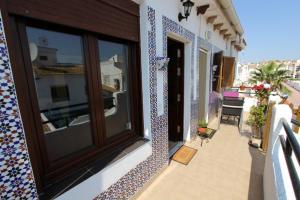 a balcony with tiles on the side of a house at Bungalow 3931 in Torrevieja
