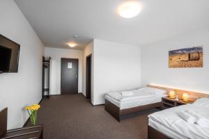 Postel nebo postele na pokoji v ubytování Hotel Na Farmě Choťovice