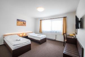 Postel nebo postele na pokoji v ubytování Hotel Na Farmě Choťovice