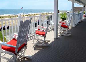 杜威海滩Adams Ocean Front Resort的海滩甲板上的一排椅子