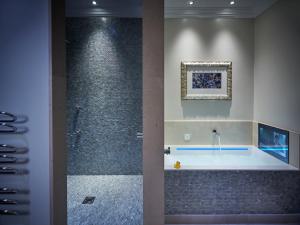 a bathroom with a tub and a shower at Lainston House in Winchester