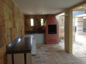 a kitchen with a counter and a brick wall at Maravilhoso Apartamento - 175 m2 in Cabedelo