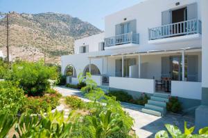 a view of a villa with a mountain in the background at Aeolos Apartments in Kamarai