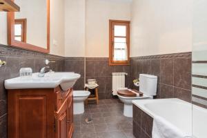 ein Badezimmer mit Waschbecken und Toilette in der Unterkunft Apartamentos Blanca Senda del Oso in Páramo + 37 Fotos