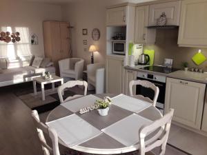 a kitchen and living room with a table and chairs at Chic En Ville in Metz