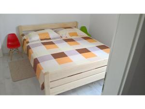 a bedroom with a bed and a red chair at San Eleuterio Guesthouse in Poreč