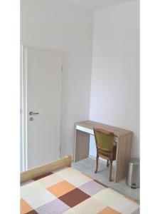 a desk with a chair in a room at San Eleuterio Guesthouse in Poreč
