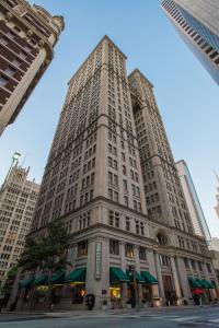 um edifício branco alto com toldos verdes em Magnolia Hotel Downtown Dallas em Dallas