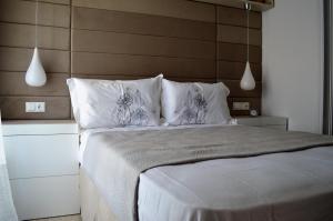 a bedroom with a large bed with white sheets and pillows at Athens Nest in Athens