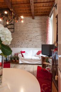 a living room with a white couch and a table at Borgo dei Salinari Apartments in Cervia