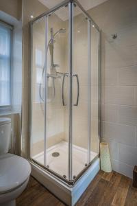 y baño con ducha y aseo. en The Golden Fleece Hotel, Thirsk, North Yorkshire, en Thirsk