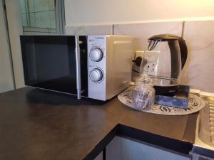 a microwave sitting on a counter next to a coffee maker at Apollo Self Catering in Vredenburg