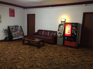 a living room with a couch and a soda machine at Roxy Hotel in Los Angeles