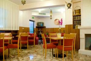 jadalnia ze stołem, krzesłami i kominkiem w obiekcie Hotel Viola w mieście Caramanico Terme