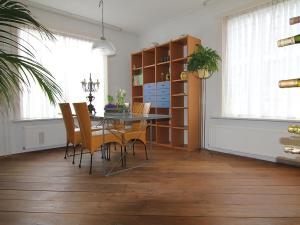 une salle à manger avec une table et des chaises en verre dans l'établissement Vakantiewoning Afterdaan, à Elim