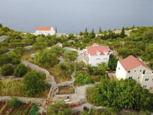 an aerial view of a house on a hill next to the water at Captain's Attic in Račišće