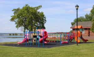 a park with a playground with a slide at Alberta Beach Inn and Suites in Albert Beach (Alberta)