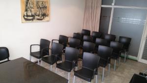 a conference room with black chairs and a table at Hotel Monte Carlo Cordoba in Córdoba