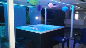 a hot tub in a room with blue lights at Hotel Almira in Agia Triada