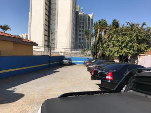 a row of cars parked in a parking lot at Hotel Orquídea -Rudge Ramos (Adults only) in São Bernardo do Campo