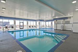 a large pool with blue water in a building at Canalta Kindersley in Kindersley