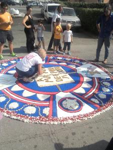 a young child is working on a rangoli in the street at Relax Brugnato in Brugnato