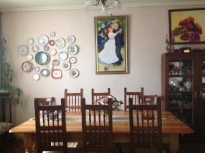 mesa de comedor con sillas y platos en la pared en Hostal Renoir, en San Fernando
