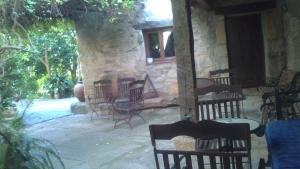 a group of chairs sitting on a patio at Casa Rural Corvina in Acebo +23 photos