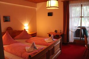 ein Schlafzimmer mit 2 Betten und Handtüchern darauf in der Unterkunft Hotel Schäfflerhof in Bischofsmais