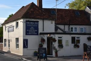 a white building with a sign in front of it at The Bell Inn in Salisbury