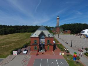 an aerial view of a building with a lighthouse in the background at Apartamenty Klifowa 7 in Niechorze