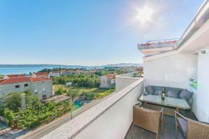 a balcony with a view of the water at Radic apartments in Kaštela
