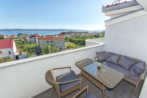 a balcony with a table and chairs and a view at Radic apartments in Kaštela