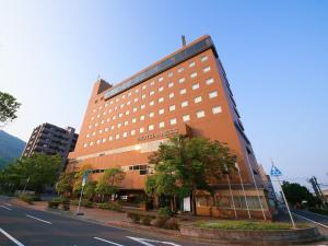a large building on the side of a street at Hotel Anesis Seto-Ohashi in Utazu