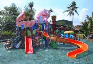 a water park with a water slide in the water at Mara River Safari Lodge Bali in Keramas