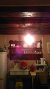a light on a shelf above a kitchen sink at The Merchant of Venice in Venice