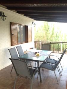 a dining table and chairs on a patio at Villa Niki in Neos Marmaras