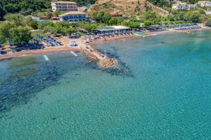 an aerial view of a beach with chairs and the water at Fiore Beach Studios in Vasilikos
