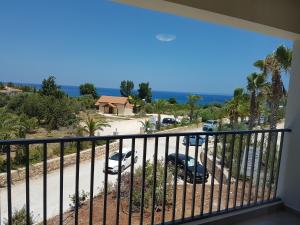 a view from a balcony of a house with a view of the ocean at Aphrodite Beach Hotel in Polis Chrysochous