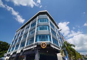 a tall glass building with a bmw sign on it at Hard Rock VIP Guest House in Mersing